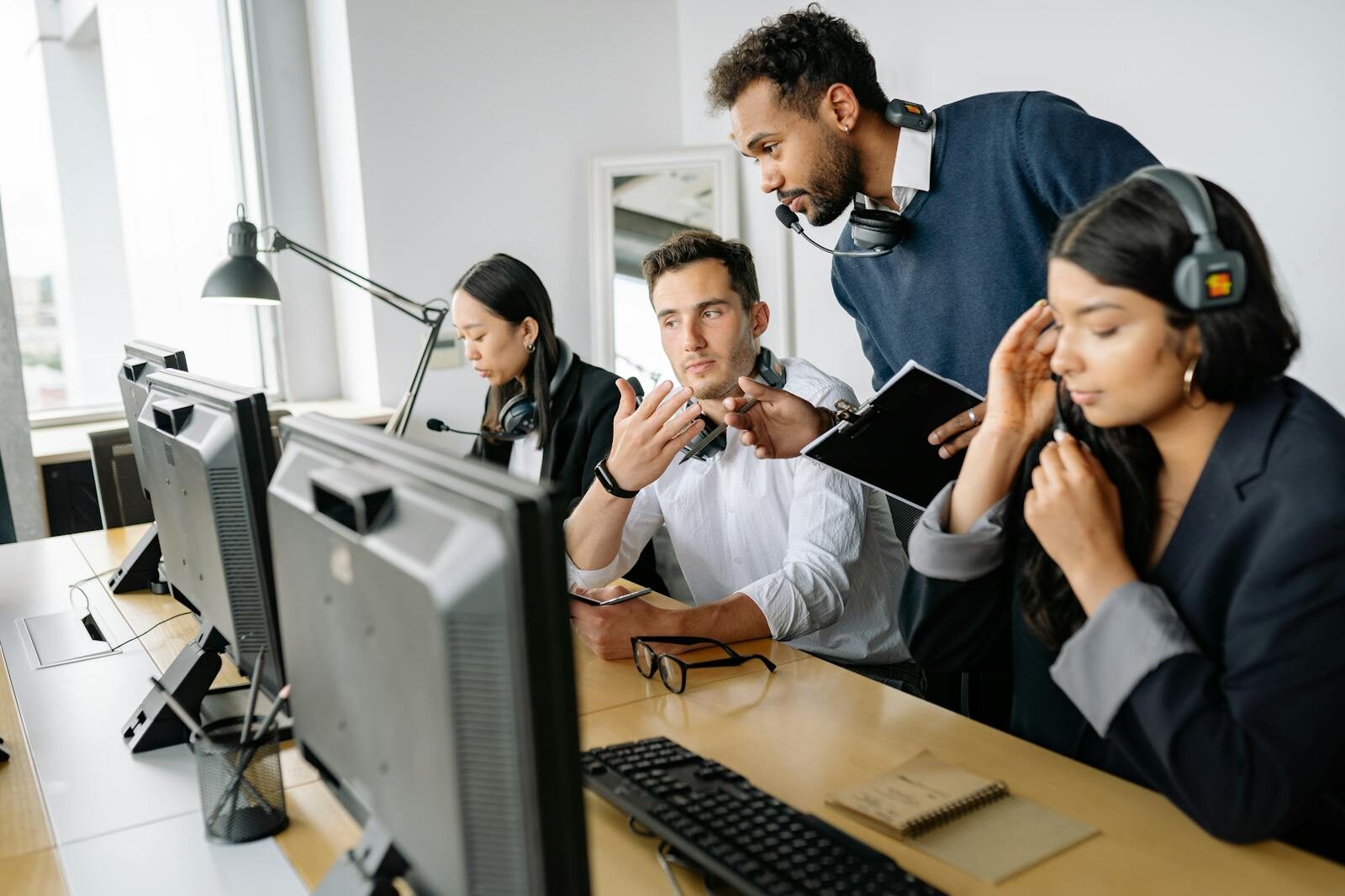 A diverse team of call center agents collaborating in a modern office environment.